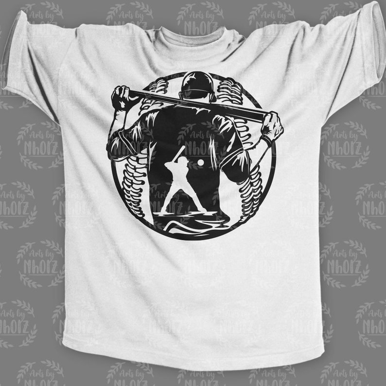 May include: A white t-shirt with a black silhouette of a baseball player holding a bat in front of a baseball. The player is facing away from the viewer.