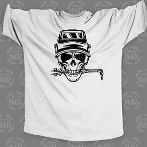 May include: A white t-shirt with a black and white illustration of a skull wearing a welding mask and holding a welding torch in its mouth.