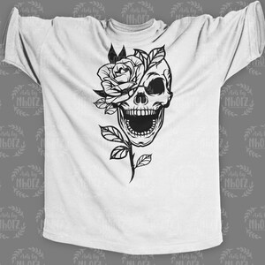 May include: A white t-shirt featuring a black and white graphic design of a skull with a rose covering one eye.
