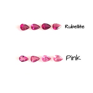 May include: Two rows of pear-shaped gemstones. The top row is labelled "Rubellite" and features five deep pink gemstones. The bottom row is labelled "Pink" and features five lighter pink gemstones.