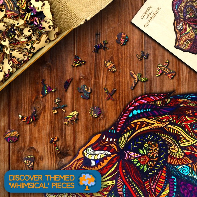 May include: Wooden jigsaw puzzle with colorful, whimsical animal-shaped pieces scattered on a wooden surface. The puzzle features a detailed illustration of a lion's face. Text on the image reads "Discover Themed 'Whimsical' Pieces" and "Caspian...the...Courageous".