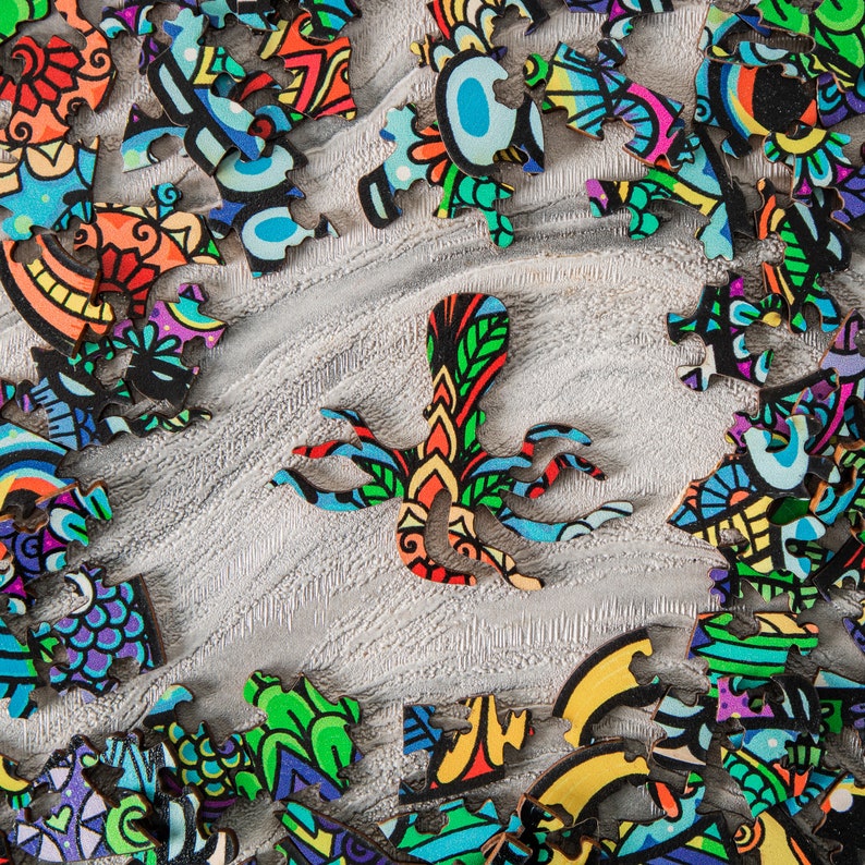 May include: A colorful jigsaw puzzle with an octopus-shaped piece in the center. The puzzle pieces are made of wood and have a variety of intricate designs.