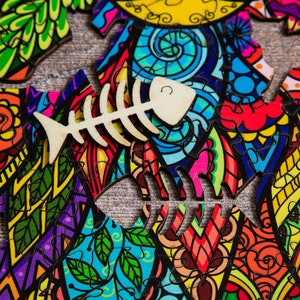 May include: A colorful jigsaw puzzle with a whimsical design featuring a cat and a fish bone. The puzzle pieces are arranged in a chaotic pattern, creating a vibrant and playful image.