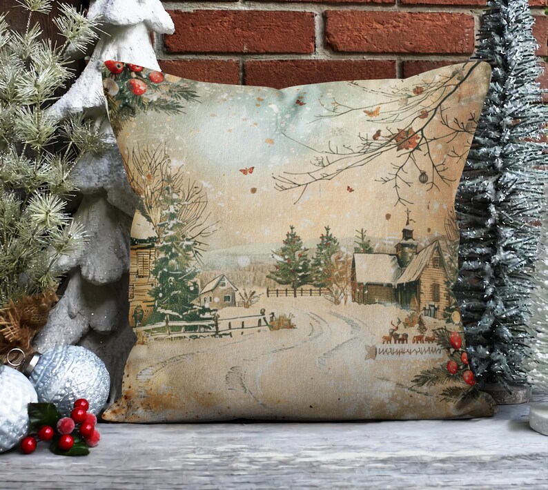 May include: A decorative throw pillow with a vintage-style illustration of a snowy winter scene. The pillow features a quaint village with houses, trees, and a winding road. The background is a soft, muted palette of browns, blues, and whites.