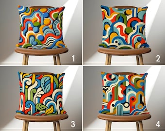 May include: Four brown chairs with cushions featuring colorful abstract patterns. The patterns are a mix of red, blue, yellow, green, and white. The chairs are arranged in a grid pattern.