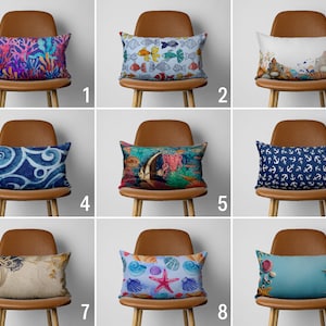 May include: Nine different pillow covers with various nautical themes. The pillows feature designs of fish, anchors, seashells, and coral. The pillows are all rectangular and have a white background.