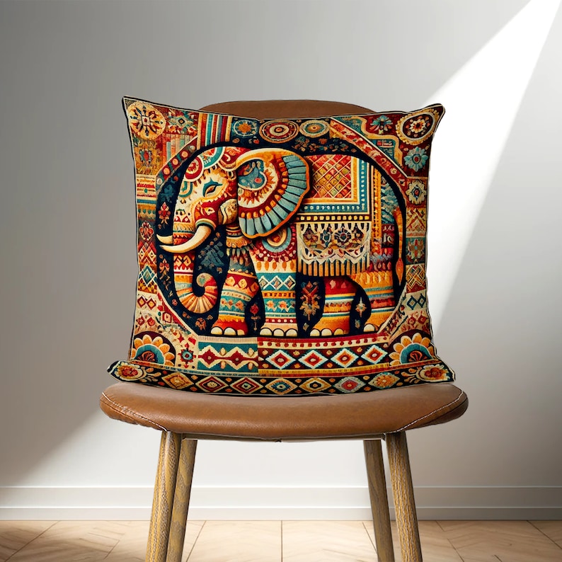 May include: A colorful throw pillow with an intricate design featuring an elephant in the center. The elephant is surrounded by geometric patterns and floral motifs in shades of red, orange, yellow, blue, and green.