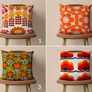 May include: Four brown chairs with different patterned throw pillows. The pillows feature a variety of floral and geometric designs in shades of orange, red, green, and white.