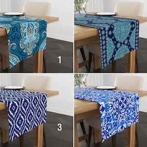 May include: Four different table runners with blue and white patterns. The table runners are on wooden tables with a white background.