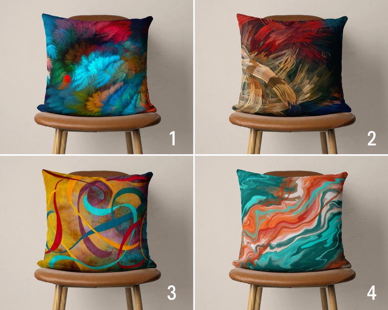 May include: Four decorative throw pillows with abstract designs. The pillows are on brown chairs with wooden legs. The pillows feature a variety of colors, including blue, red, yellow, orange, and green.