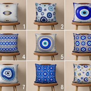 May include: Nine different pillow covers with various blue and gold evil eye designs. The pillows are displayed on wooden chairs with a white background.