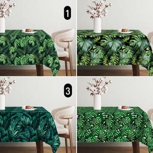 May include: Four images of a green and white tropical leaf patterned tablecloth on a table with a white vase and white cotton flowers. The table is set with two chairs and a plate with a small cake on it. Each image is numbered 1 through 4.