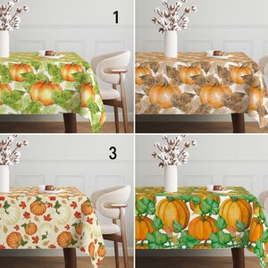 May include: Four different tablecloths with a fall theme featuring pumpkins and leaves. The tablecloths are in various colors, including green, brown, and cream.