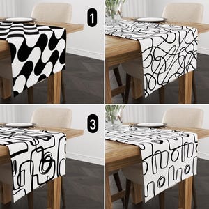 May include: Four black and white table runners with different geometric patterns. The table runners are on wooden tables with chairs.