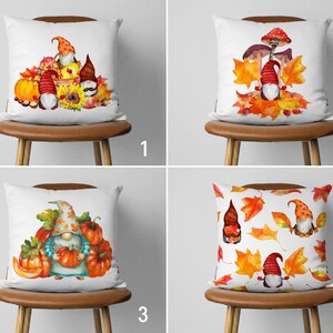 May include: Four different pillow designs featuring gnomes and autumnal elements. The first pillow has three gnomes with pumpkins, leaves, and sunflowers. The second pillow has a gnome sitting on a mushroom with leaves. The third pillow has a gnome holding a pumpkin with pumpkins and leaves. The fourth pillow has two gnomes with leaves and a mushroom.