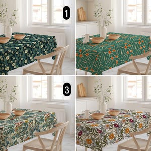 May include: Four different floral patterned tablecloths on display. Each tablecloth is rectangular and covers a wooden table. The patterns include dark green with white flowers, green with orange flowers, a floral pattern with green and beige, and a floral pattern with yellow and purple.