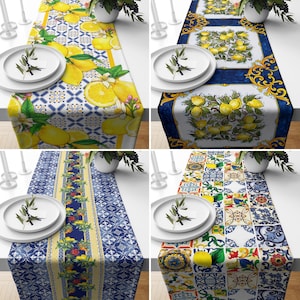 May include: Four table runners with a blue and white tile pattern and lemons. The table runners are made of fabric and have a decorative design.