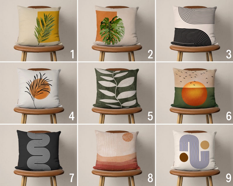 May include: Nine different throw pillow designs with various abstract patterns and colors. The pillows are displayed on chairs with wooden legs.