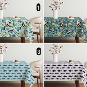 May include: Four different tablecloths with a fish design. The first tablecloth has a blue background with colorful fish. The second tablecloth has a green background with colorful fish. The third tablecloth has a light blue background with blue fish. The fourth tablecloth has a beige background with blue fish.