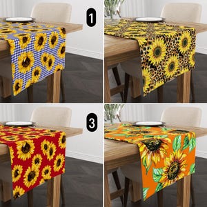 May include: Four table runners with sunflower designs. The first has a blue gingham pattern with sunflowers. The second has a leopard print background with sunflowers. The third has a red background with sunflowers. The fourth has an orange background with sunflowers and green leaves.