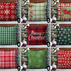 May include: Nine different Christmas pillow designs featuring various patterns and colors, including red, green, white, and black. Some pillows feature snowflakes, plaid, and gingham patterns. One pillow has the text "Merry Christmas" on it.