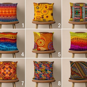 May include: Nine colorful throw pillow covers with different geometric and abstract patterns. The pillows are arranged in three rows of three, each pillow on a wooden chair.