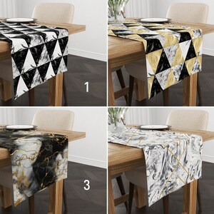 May include: Four table runners with different geometric and marble patterns. The runners are black, white, and gold. The runners are on wooden tables with chairs.
