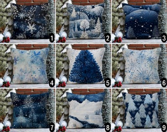 May include: Ten different pillow covers with wintery designs. The designs include snowflakes, trees, and a snowy landscape. The pillow covers are all blue and white.