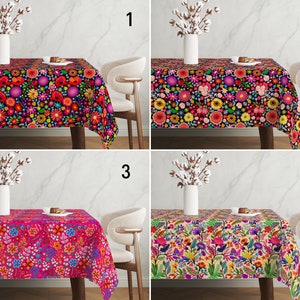 May include: Four different floral tablecloths with a variety of colors and patterns. The tablecloths are shown on a table with a white chair in front of each one. The tablecloths are all rectangular and have a fringed edge.