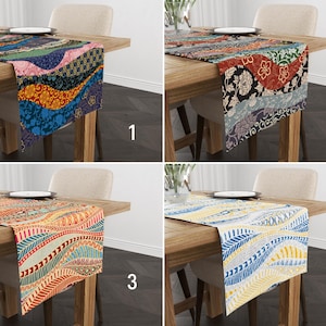 May include: Four different table runners with colourful geometric patterns. The runners are shown on wooden tables with chairs. The patterns include blue, green, red, yellow, and orange.