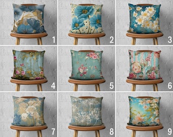 May include: Nine different pillow covers with various floral and abstract patterns on a blue background. The pillows are displayed on chairs with wooden legs.