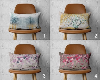 May include: Four brown chairs with different patterned throw pillows. The pillows feature a forest scene, a tree with yellow leaves, a floral pattern, and a pink floral pattern with a butterfly.