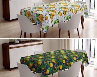 May include: Two dining tables with chairs, each featuring a different tablecloth. One tablecloth is white with a lemon and flower pattern, the other is dark blue with a lemon and leaf pattern.
