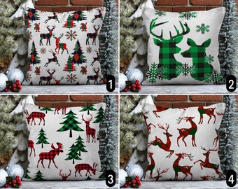 May include: Four different Christmas pillow designs featuring red and green plaid reindeer and Christmas trees. The pillows are white with a subtle linen texture.