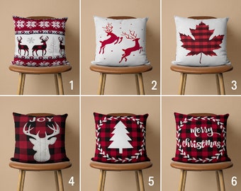May include: Six different pillow covers with a Christmas theme. The covers feature red and black buffalo plaid with various designs including reindeer, a Christmas tree, a maple leaf, and the words "Joy" and "Merry Christmas".