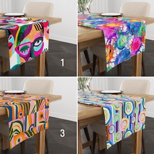 May include: Four different table runners with colorful abstract designs. The designs include a colorful face, watercolor splatters, geometric shapes, and circles.