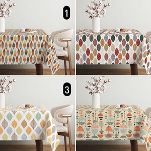 May include: Four different tablecloths with geometric patterns. The tablecloths feature a variety of colours, including red, orange, yellow, green, blue, and white. The tablecloths are all rectangular and have a fringed edge.