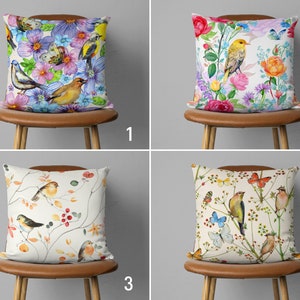 May include: Four decorative throw pillow covers featuring floral and bird designs. The pillows showcase watercolour-style illustrations of birds, flowers, and butterflies on a white background. The pillows are arranged in a grid pattern against a light grey backdrop.