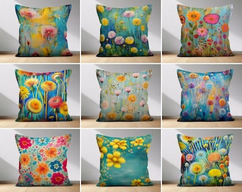 May include: Set of ten decorative throw pillow covers featuring various floral patterns. The pillows are all rectangular and have a blue background with colorful flowers and leaves. The patterns include a variety of flowers, including dandelions, daisies, and roses.