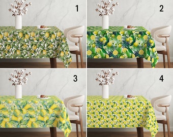 May include: Four different lemon-themed tablecloths with a white background and various lemon designs. The tablecloths are displayed on a table with a white chair in front of each one. The tablecloths are numbered 1 through 4.
