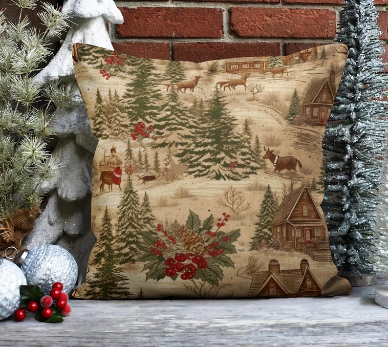 May include: A decorative throw pillow with a winter woodland scene featuring a cabin, trees, and animals. The background is a beige color with a subtle pattern. The pillow is made of a soft, brown fabric.