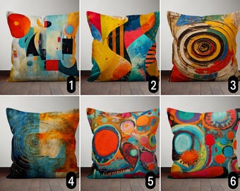 May include: Six colorful throw pillows with abstract designs. The pillows feature a variety of colors, including yellow, blue, red, orange, and green. The designs are geometric, abstract, and swirling.