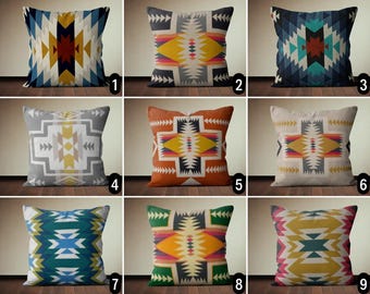 May include: Nine different throw pillow covers featuring geometric patterns in shades of blue, yellow, orange, red, and grey. The patterns are inspired by Native American designs.
