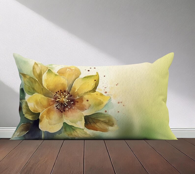 Peut inclure: Un oreiller en aquarelle avec une fleur jaune et des feuilles vertes sur un fond vert clair.