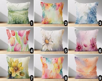 May include: Ten different watercolor pillow covers with floral designs. The designs include tulips, daisies, hydrangeas, and other flowers. The pillow covers are all white with a light watercolor background.