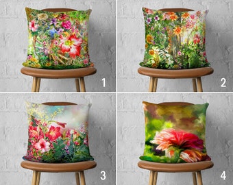 May include: Four different floral pillow covers with a variety of colorful flowers and green foliage. The pillow covers are displayed on brown chairs against a white brick wall.