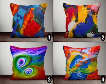 May include: Four colorful throw pillows with abstract designs. The pillows are arranged in a grid pattern on a wooden floor. The pillows are all different colors and have different abstract designs.