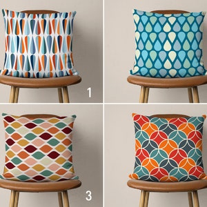 May include: Four different pillow covers with geometric patterns. The first pillow cover has a blue and orange pattern of teardrop shapes. The second pillow cover has a blue and white pattern of teardrop shapes. The third pillow cover has a red, orange, and green pattern of curved shapes. The fourth pillow cover has a red, orange, and blue pattern of circles.