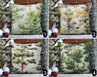 May include: Four different pillow covers with watercolor pine tree designs. The first pillow cover features a green and white pine tree design. The second pillow cover features a yellow and white pine tree design. The third pillow cover features a green and brown pine tree design. The fourth pillow cover features a green and white pine tree design with white flowers.