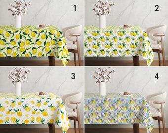 May include: Four tablecloths with different patterns. The first two tablecloths feature a lemon print on a white background. The third tablecloth has a lemon print on a white background with a lavender floral pattern. The fourth tablecloth has a lavender floral pattern with a lemon print on a light blue background.